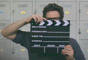 man-in-glasses-using-a-clapperboard.gif