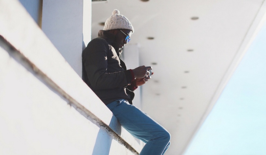 Trendy-modern-man-playing-game-on-smartphone-outside Trendy-modern-man-playing-game-on-smartphone-outside