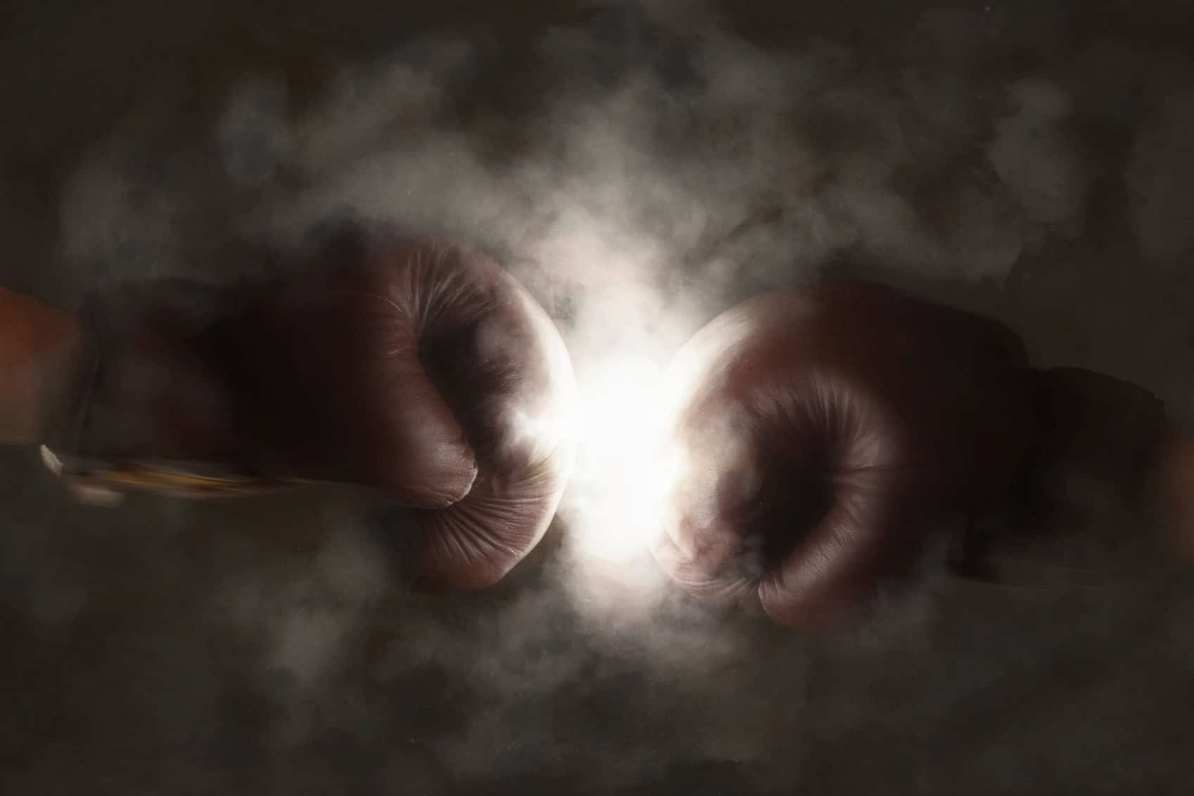 boxing-gloves-hitting-each-other-in-the-spotlight
