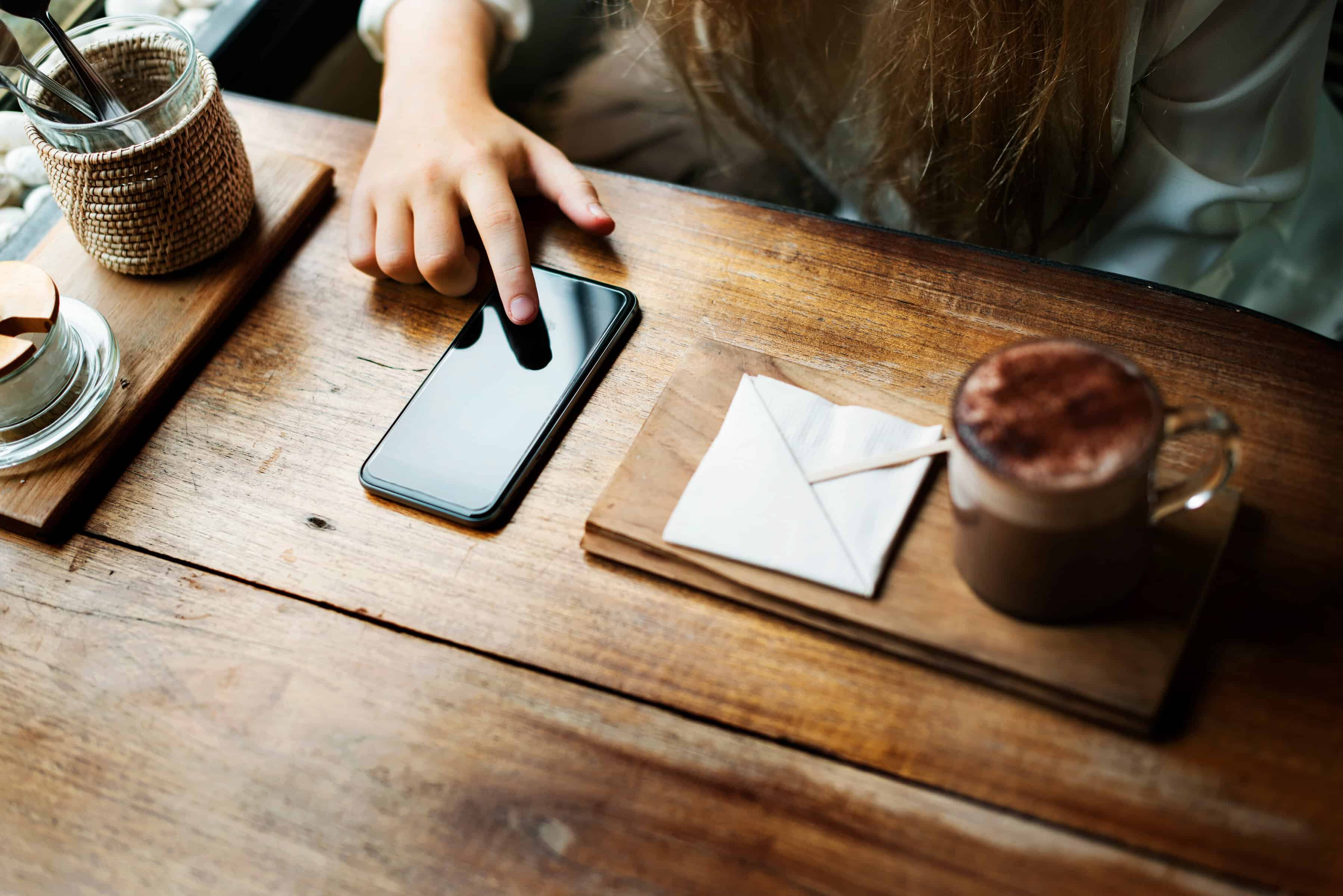 receiving-mobile-notifications-and-using-smartphone-at-coffee-shop receiving-mobile-notifications-and-using-smartphone-at-coffee-shop